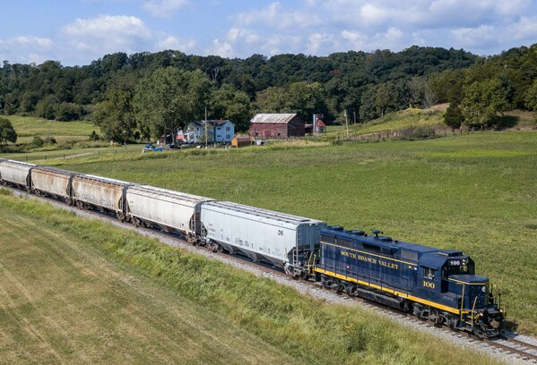 Blue locomotive pulling freight cars