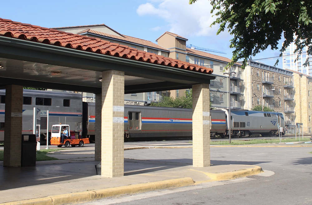 Passenger train in background with station in foreground