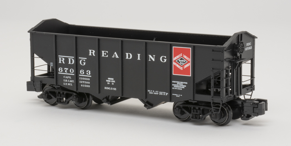 Color photo of S gauge freight car painted black with white and red graphics.