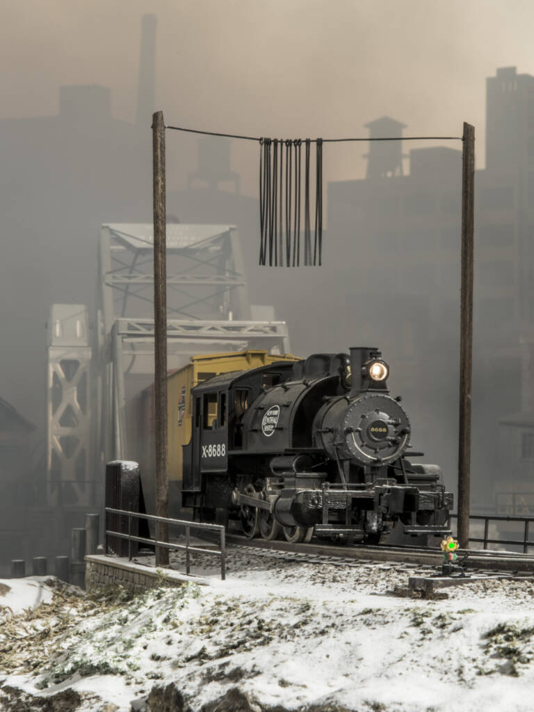 steam locomotive on bridge in snowy scene