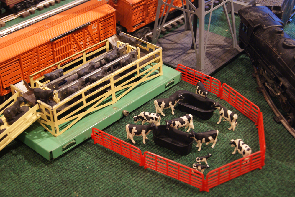 scene on layout of cattle in pen next to train tracks