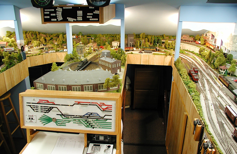 A model train layout under the slanted roof of an attic