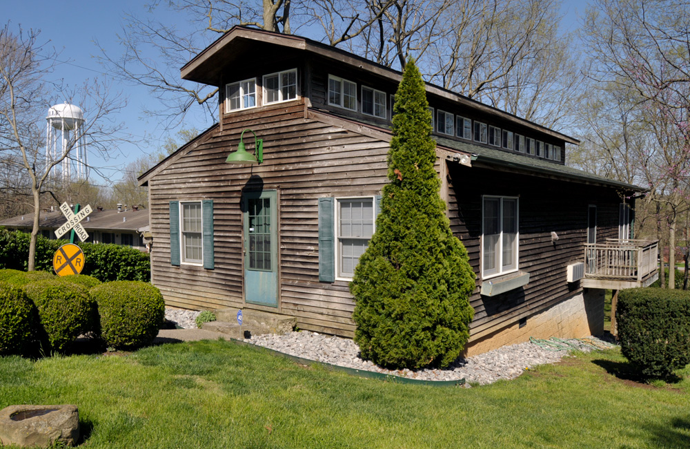 A wood-sided outbuilding with a clerestory roof