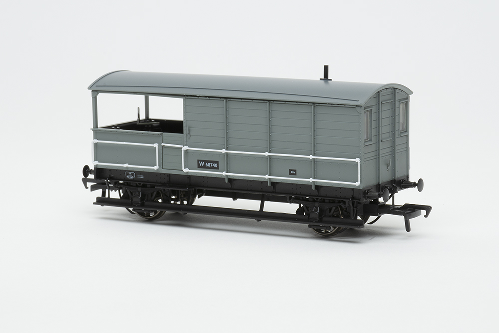 Gray and black model train car with white handrails and open porch on the back.