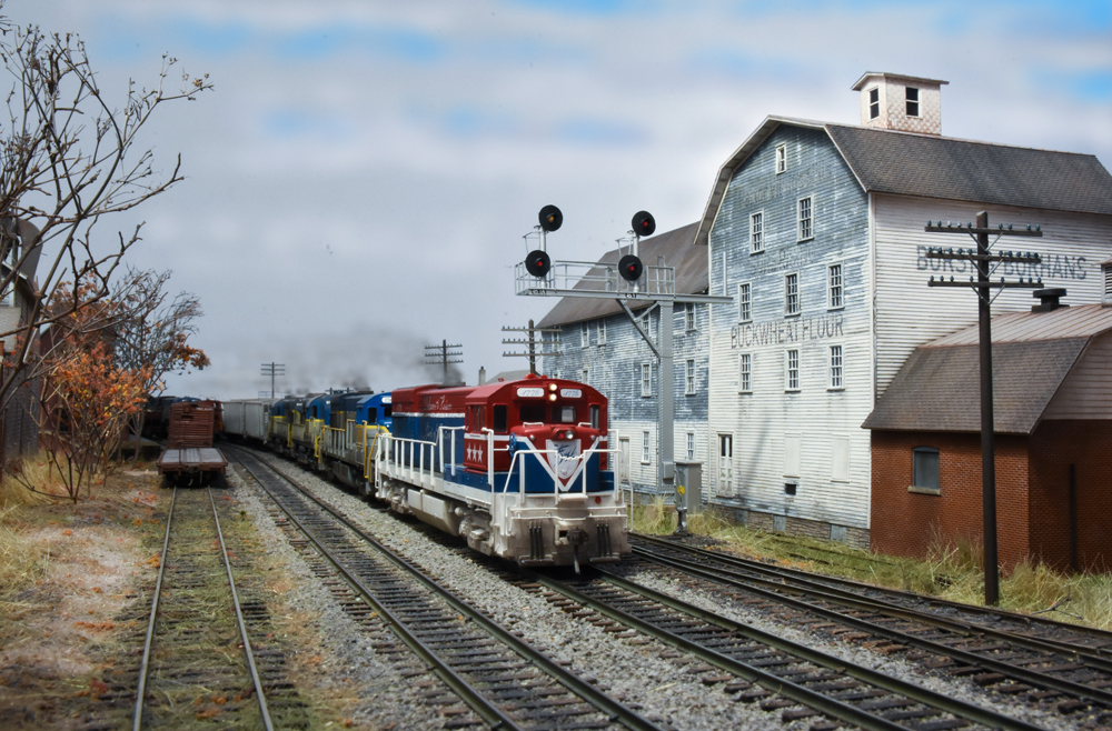 model locomotive next to white building
