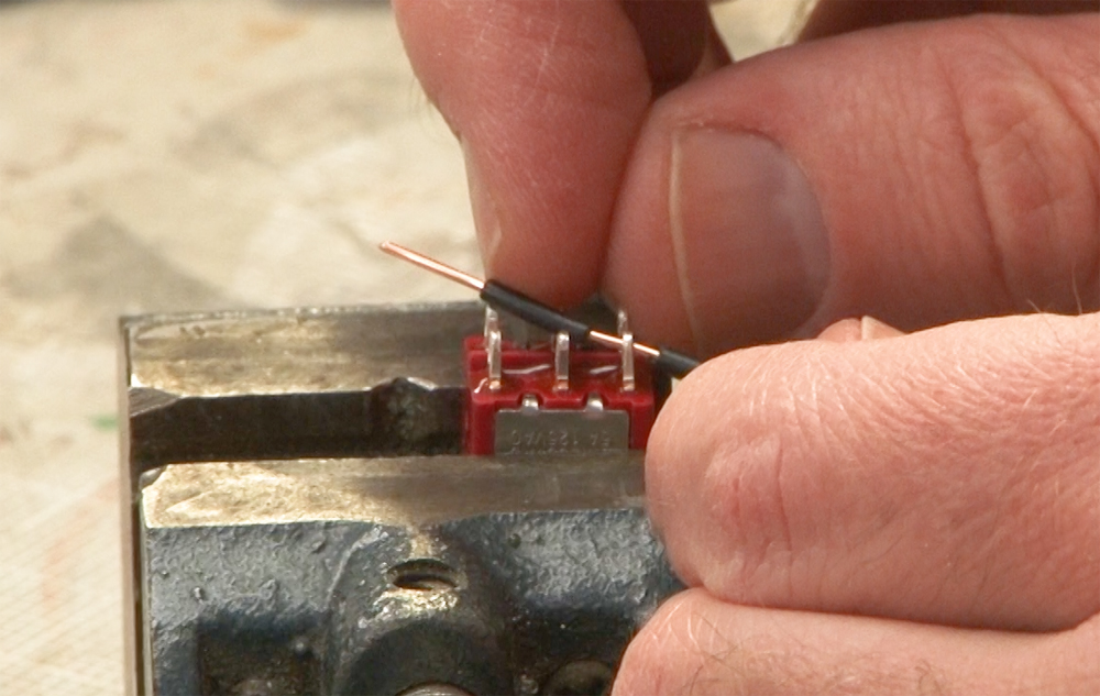 Photo showing reinstalling plastic casing on solid wire.