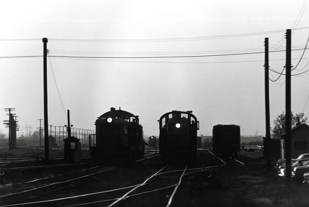 black and white photo of three diesels on railroad