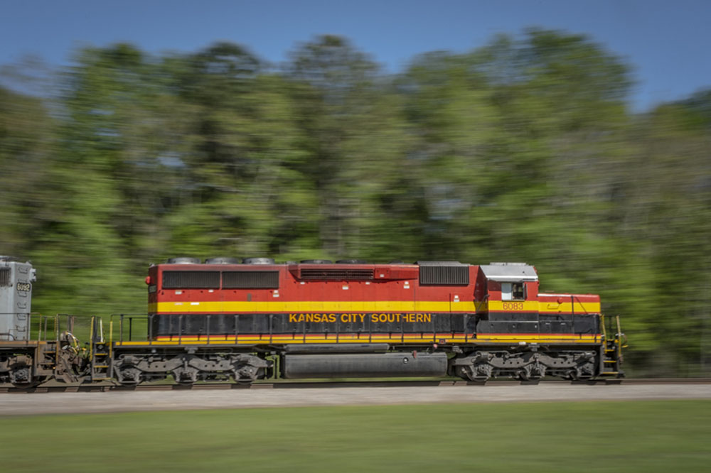 red, yellow and black diesel locomotive moving fast