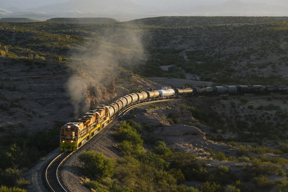 train going around curve in sunrise