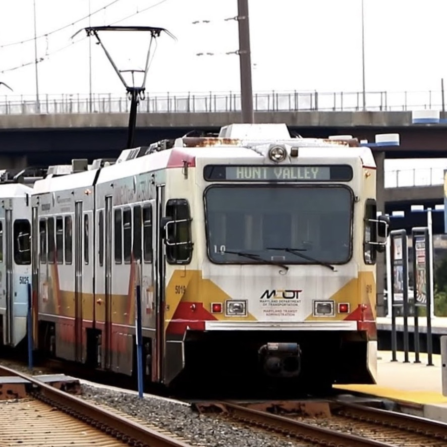 White, red, and yellow light rail trainset