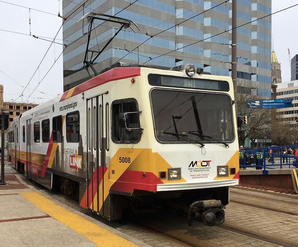 Red, yellow, and white light rail trainset