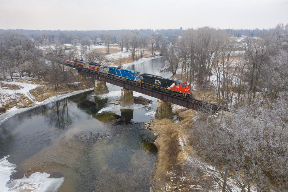 Canadian National and lease locomotive with Iowa Northern locomotives on bridge