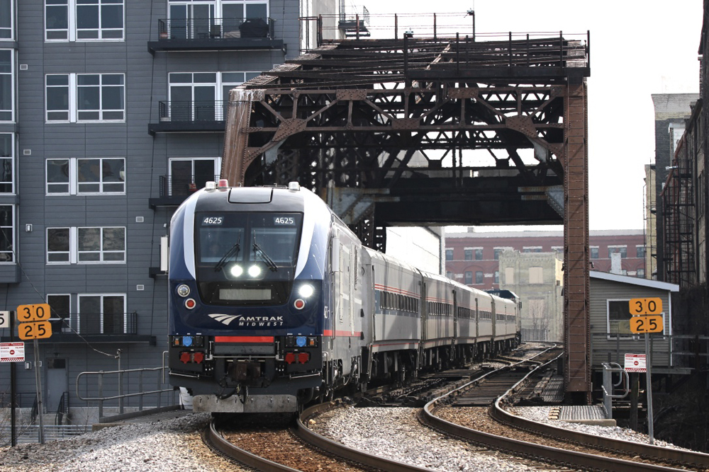 Passenger train crossing bridge