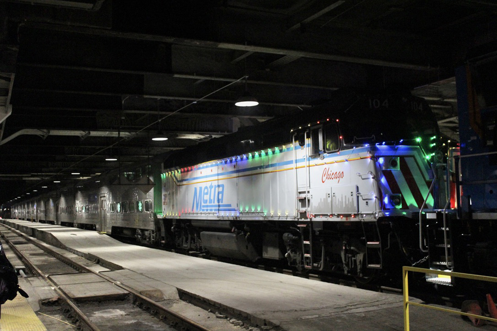 White locomotive with holiday lights