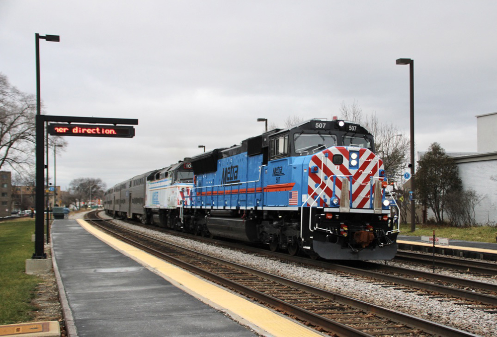 Blue and white locomotives lead commuter train