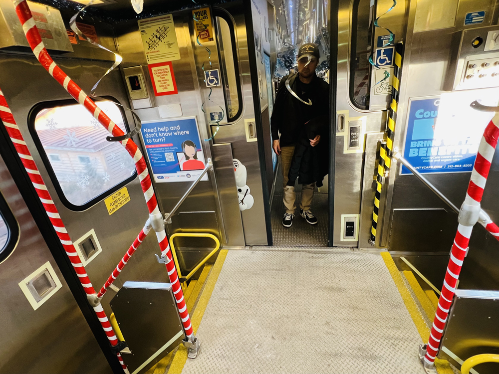 Striped handrails at stairwell of gallery commuter car