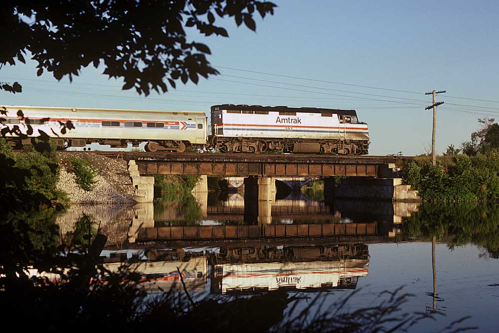 Amtrak Toledo services passenger train crossing low bridge over waterway
