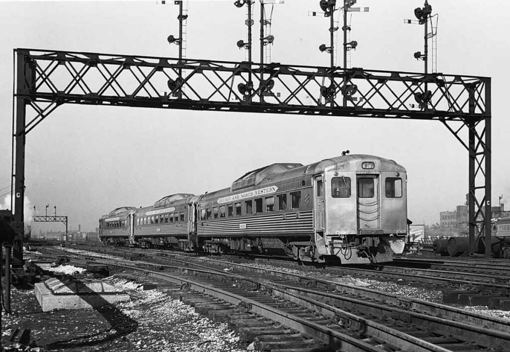 Stainless steel Budd Rail Diesel Car (RDC) under signal bridge