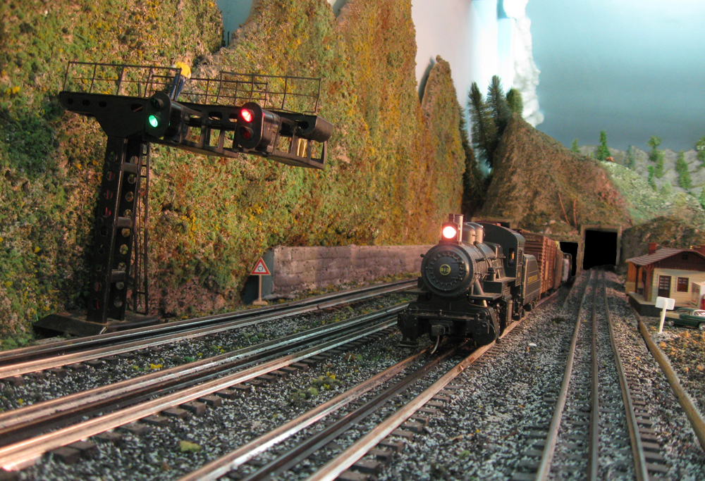 model steam train with headlight on layout