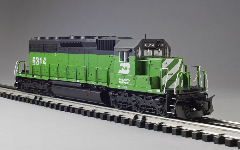 green, black, and white model locomotive on track