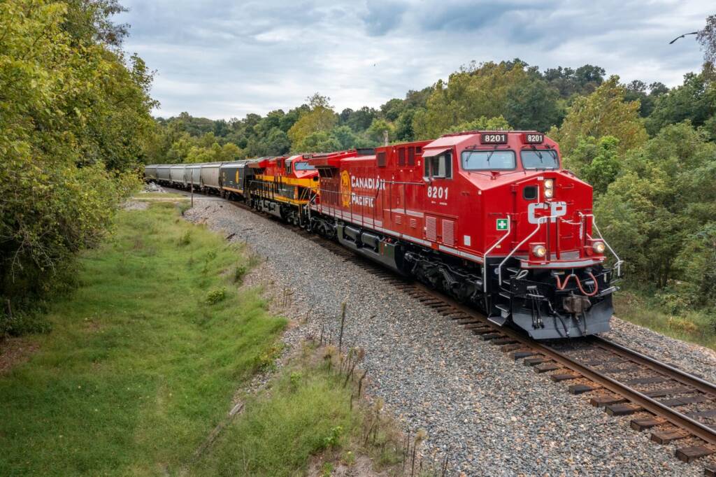 Grain train led by red locomotive