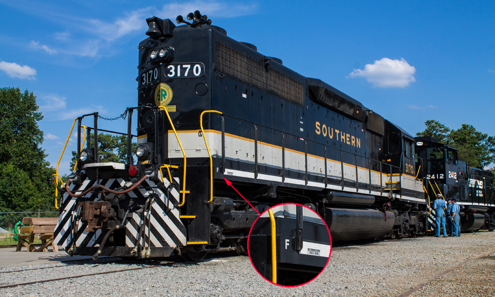 A black-and-white diesel hood unit seen in three-quarters view on a sunny day