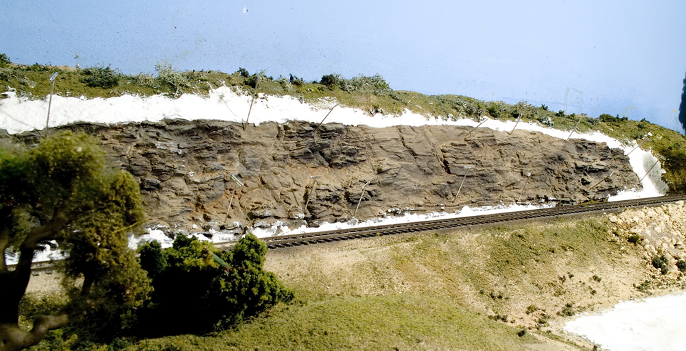 Color photo of scenery work on an HO scale model railroad.