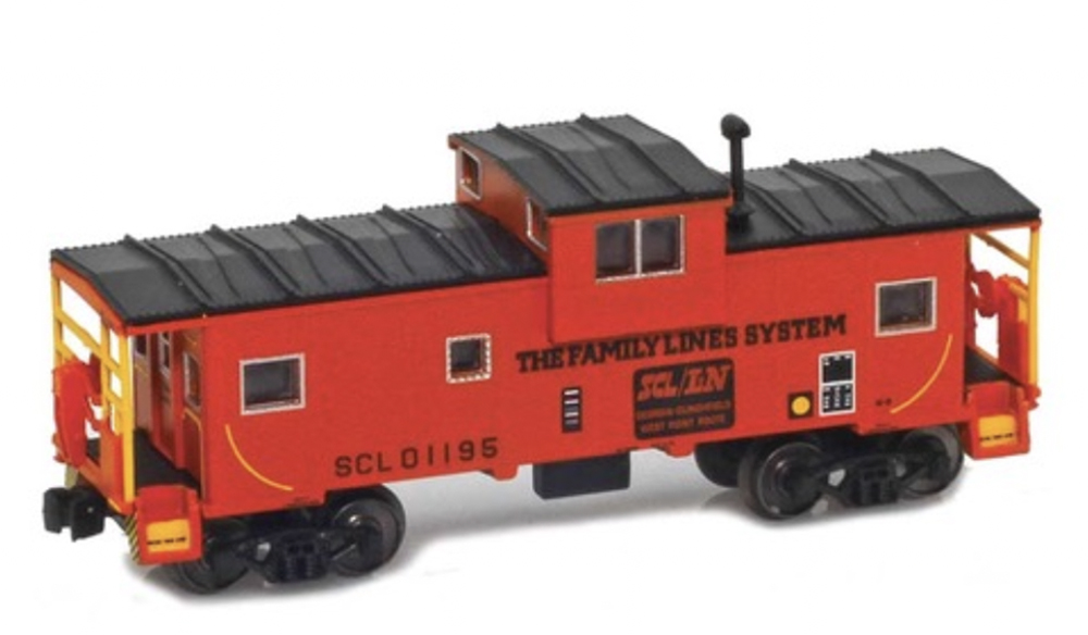 A model caboose in a red paint scheme with a black roof