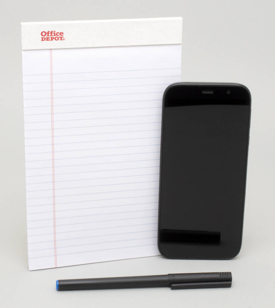 Photo showing tools, cell phone, notepad, and pen.