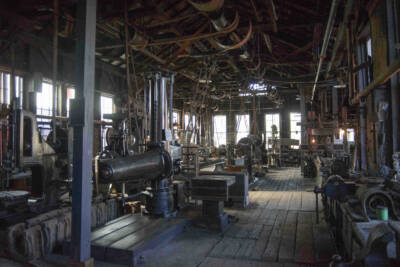 Early 1900s machine shop with belts and pullies.