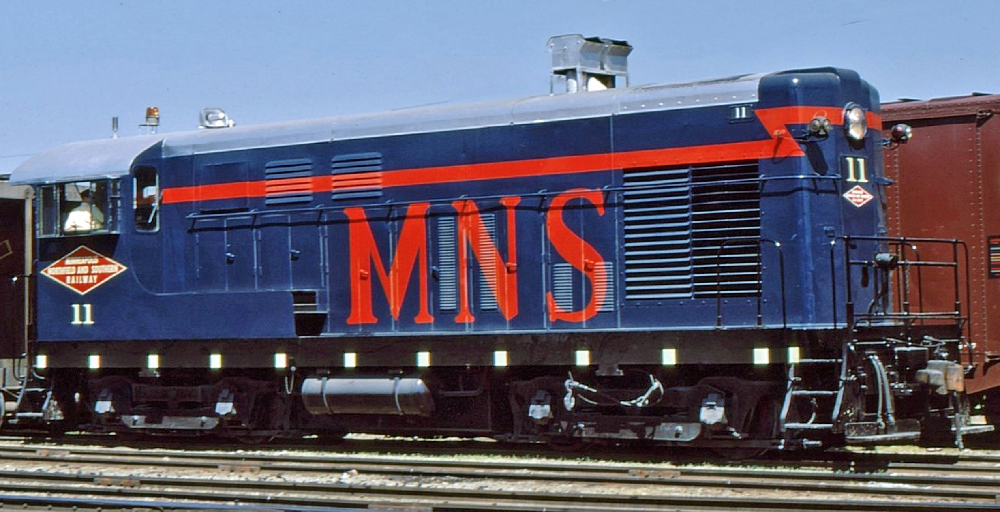 Blue, silver, and orange diesel switch engine