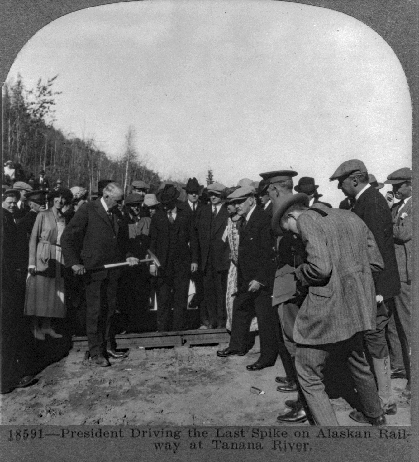 Group of people gathered by a railroad track