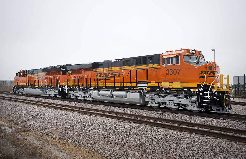 orange, black and yellow locomotive on track