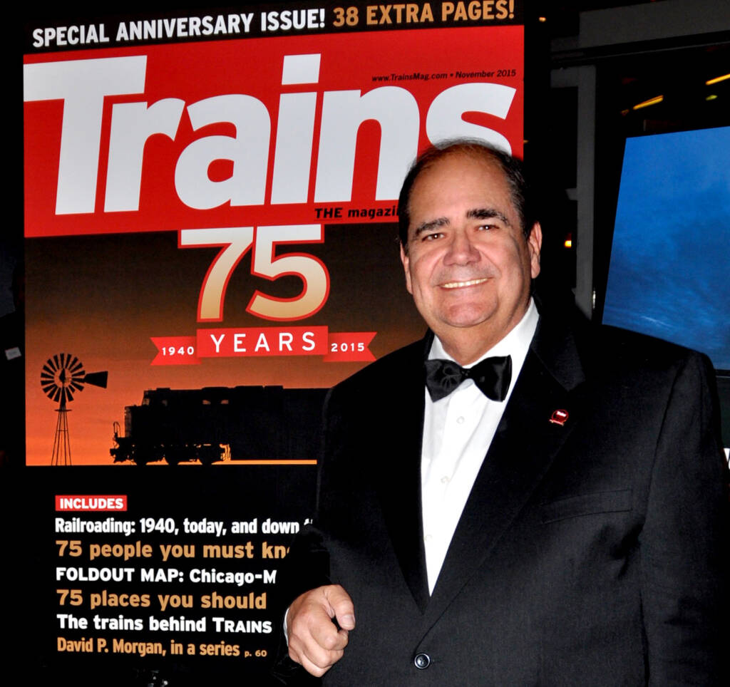 man in front of giant magazine