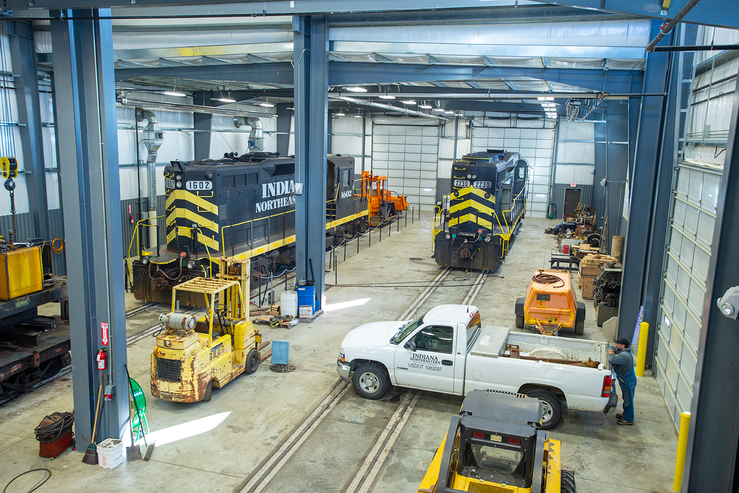 locomotives inside shop with white truck
