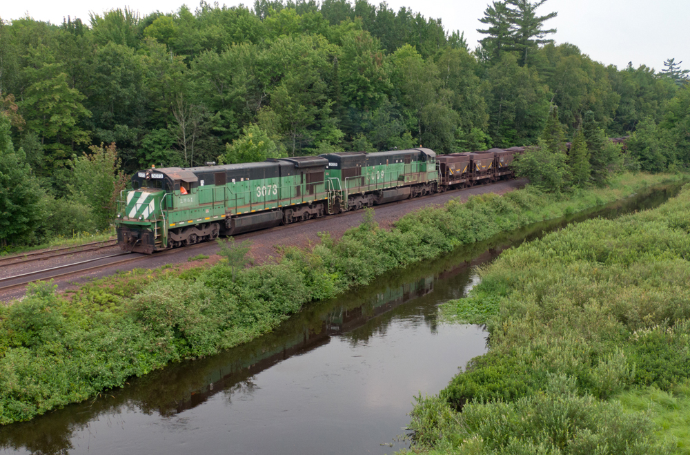 green and black locomotive on track