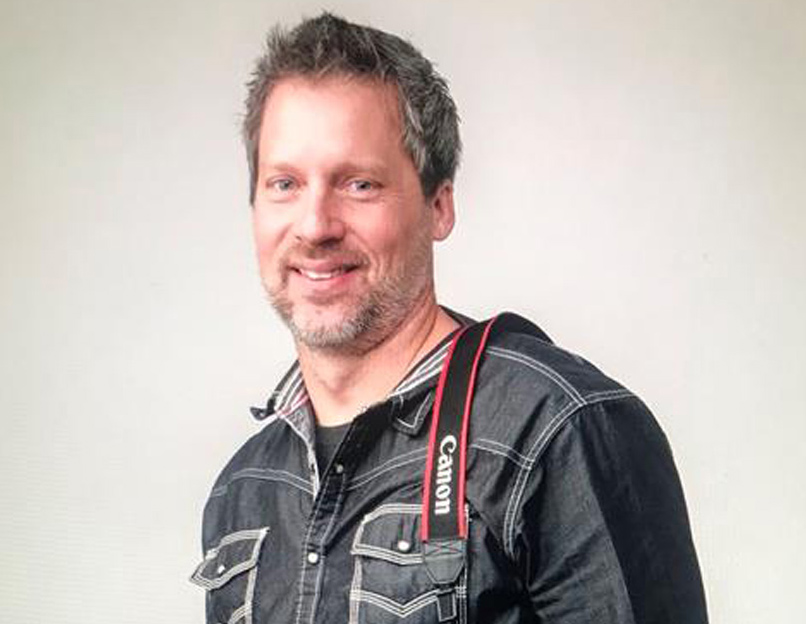 headshot of man with camera