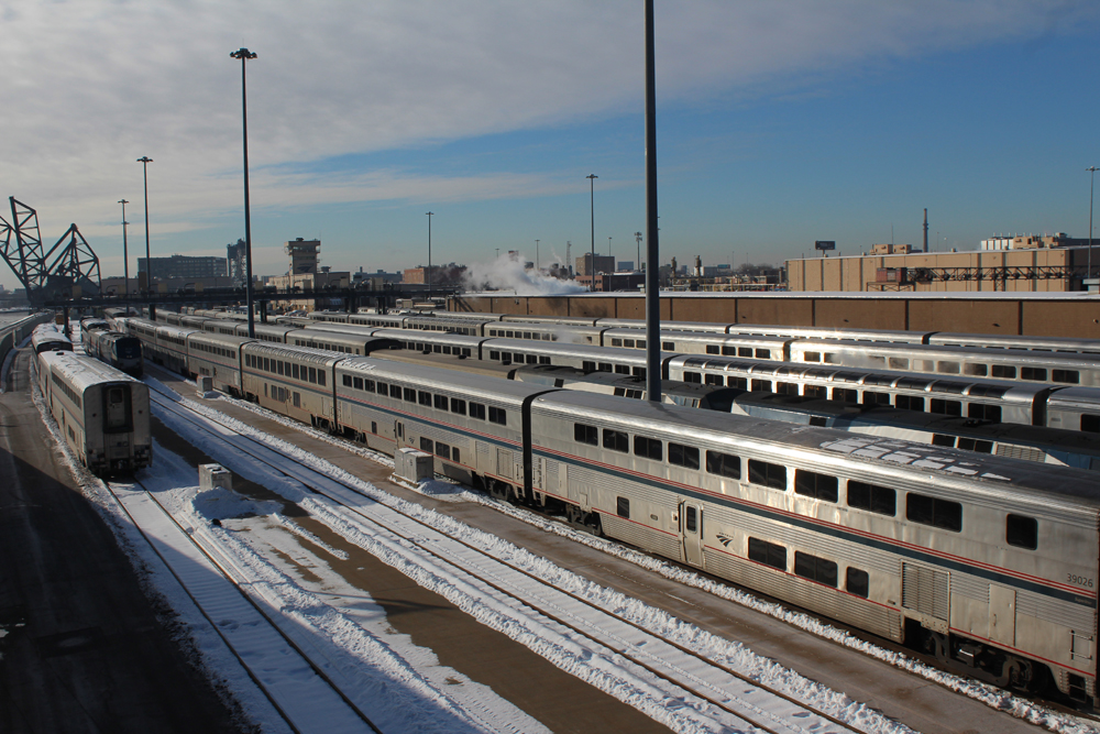 Passenger cars in yard with snow on ground