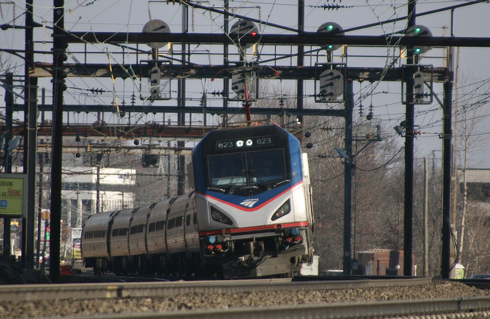 Passenger train with electric locomotive on curve