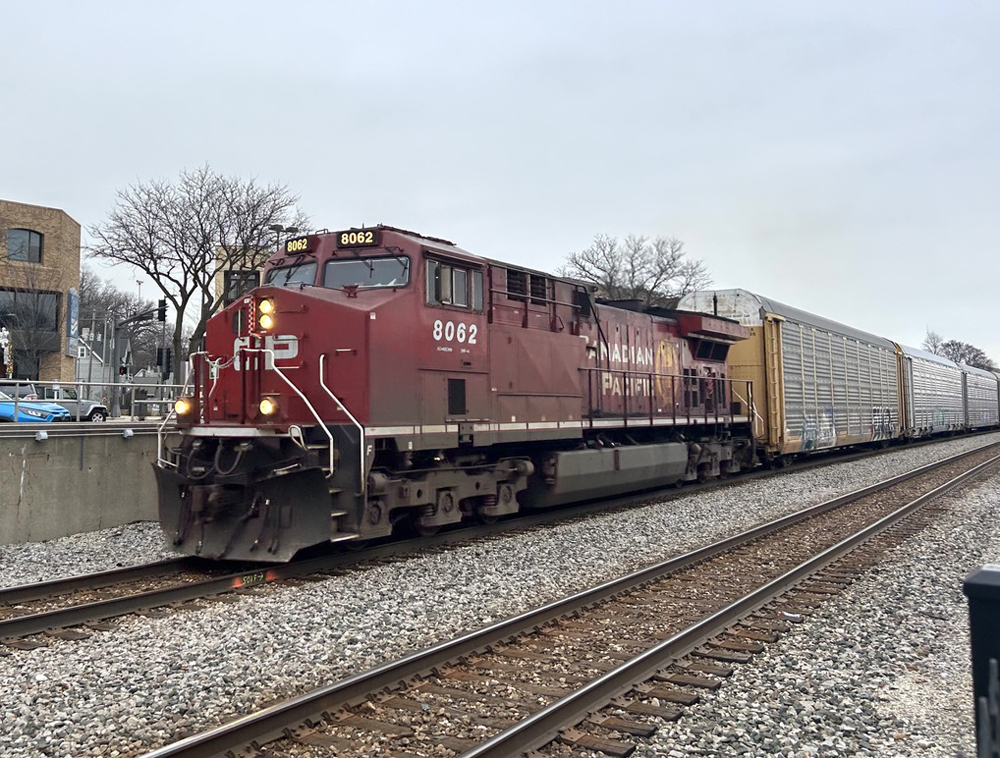 Red locomotive with auto racks