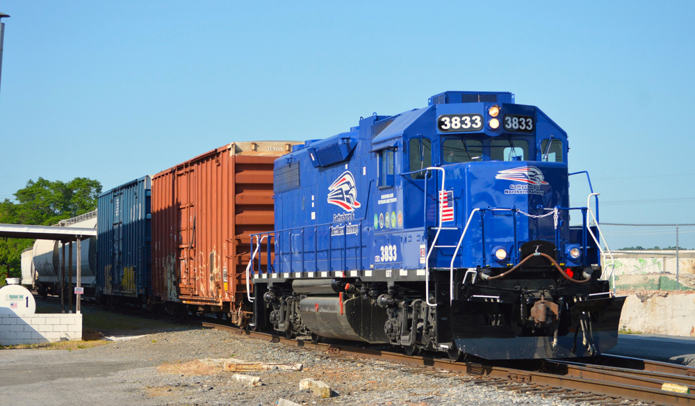Blue lcomotive with freight cars