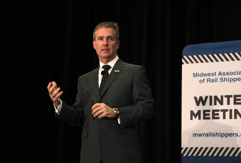 Man speaking with dark background