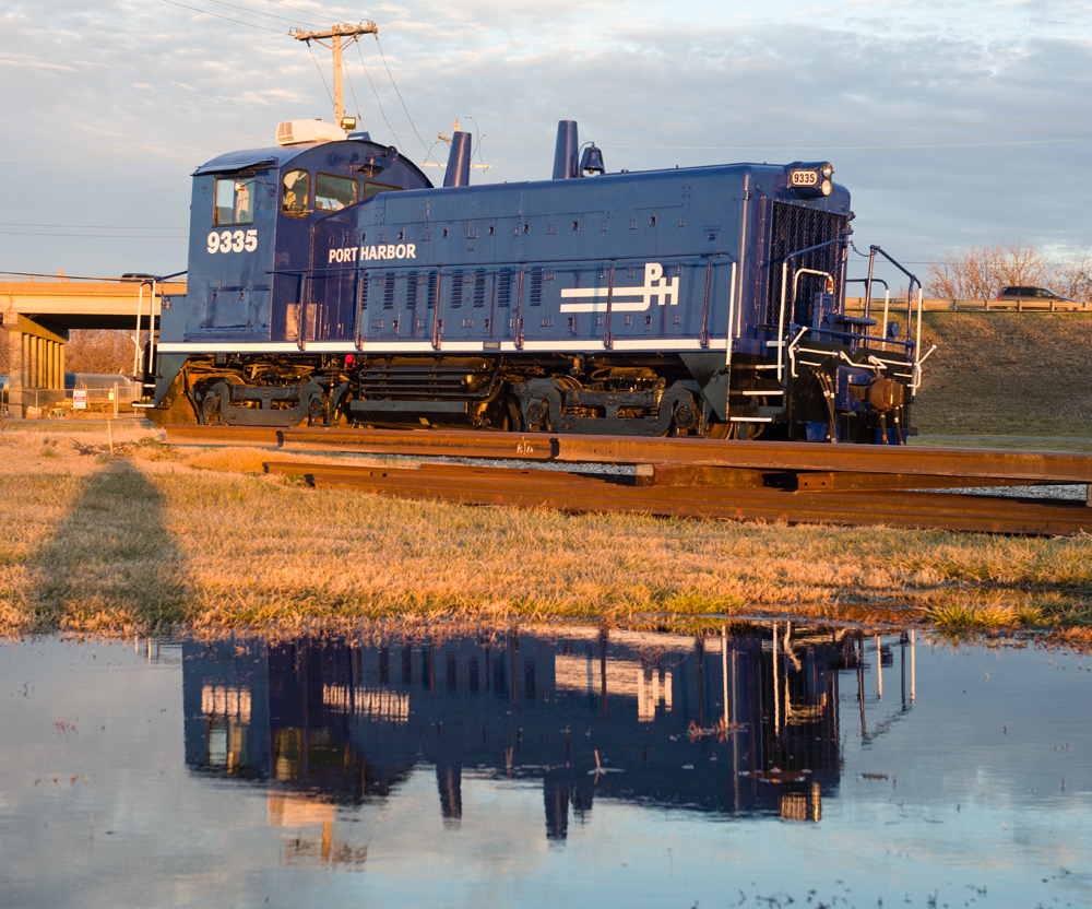 Blue switch engine reflected in water