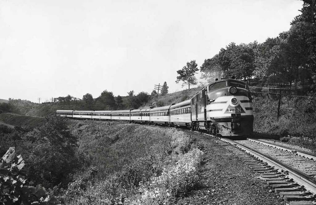 Streamlined diesel locomotive with passenger train on curve