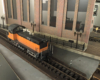 close up of model track with black and orange locomotive