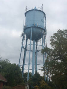 vintage water tower with clouds