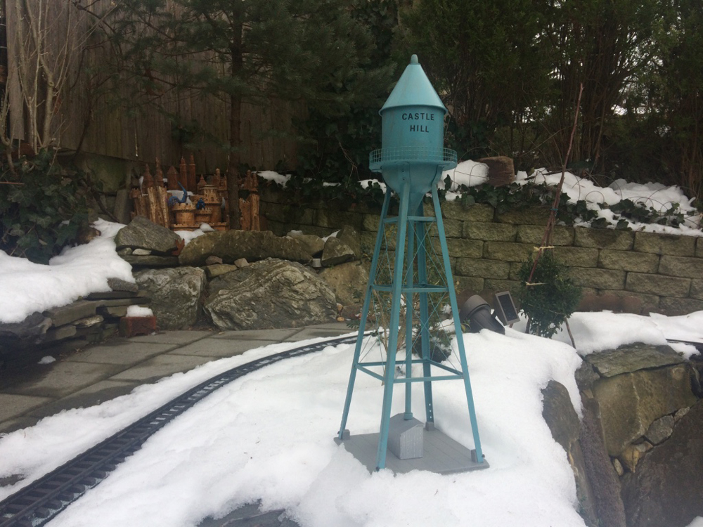 teal model water tower on garden railway