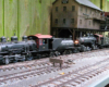 Locomotive next to fence on garden railway