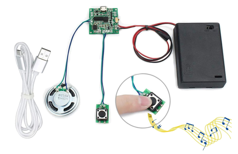 A small circuit board attached to a speaker, activation button, and battery pack