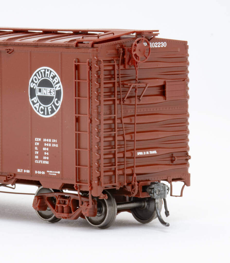 Color image showing details on HO scale boxcar painted brown with black-and-white graphics.